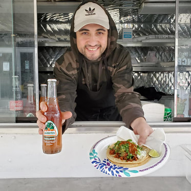 Serving Taco and Jarritos Beverage at Taqueria Ranchos Mexican Food Truck in Buffalo New York